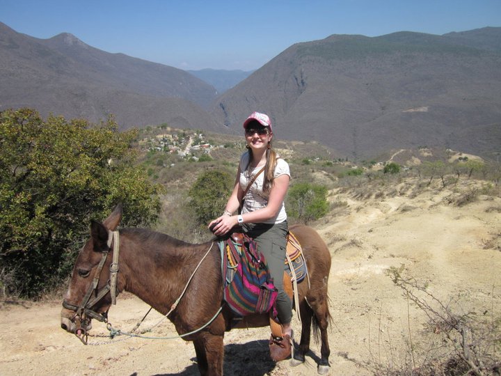 A B Corp certification adviser riding a horse in Mexico, wearing a white t-shirt